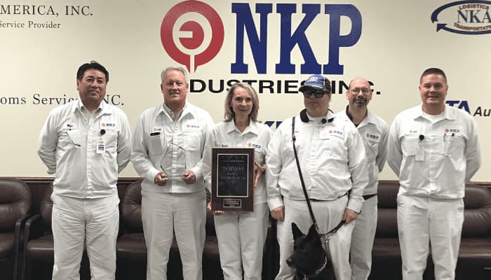 NK Parts employeess holding the springbuk healthiest 100 workplaces award